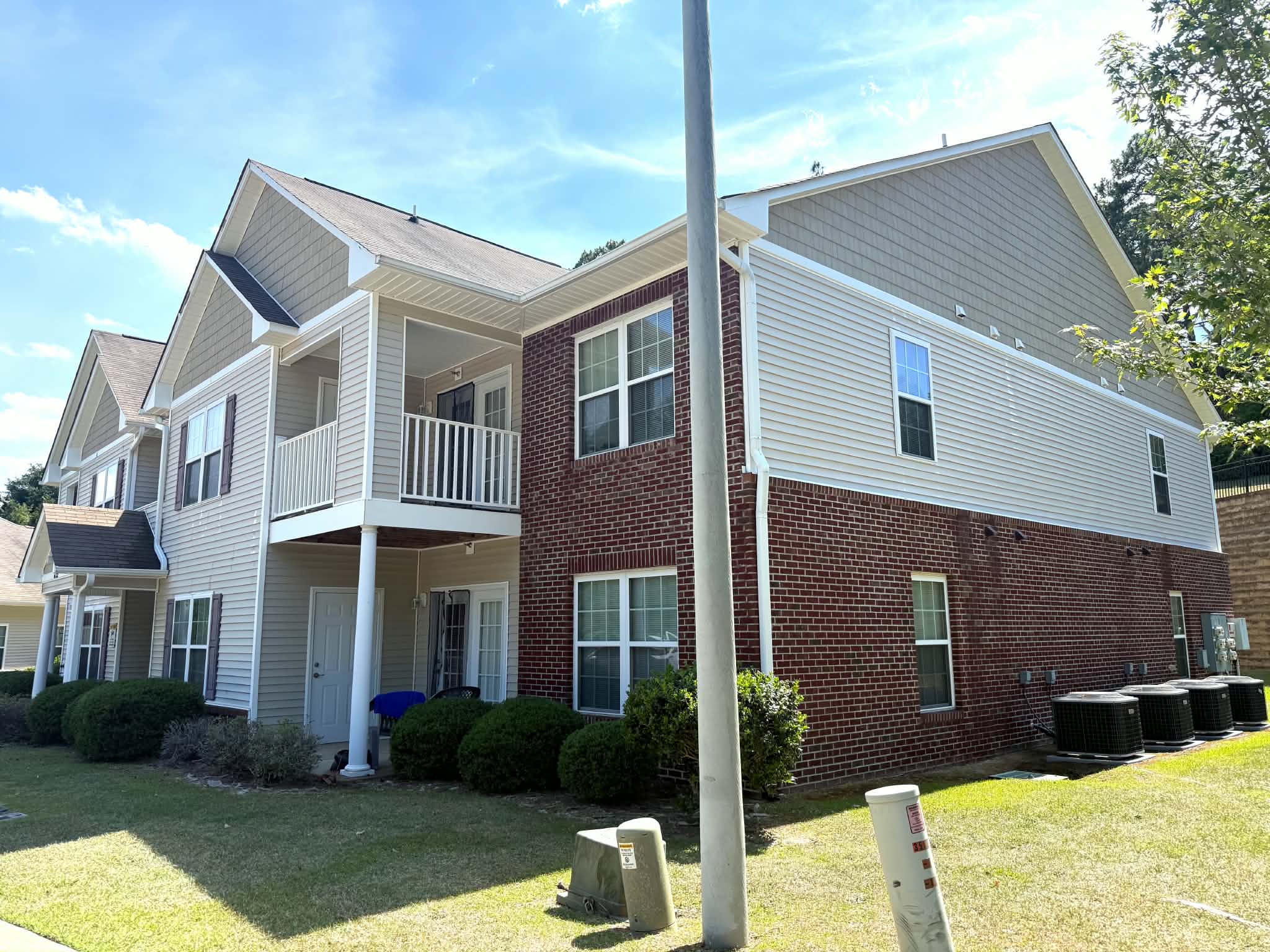 Apartment building exterior siding and brick soft washed by P3